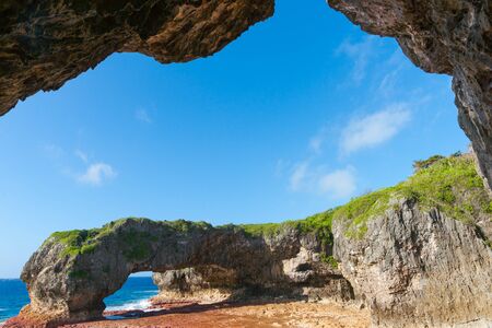 Scenic natural arch on coast of island Talava Arch framed by coral ledge, Niueの写真素材