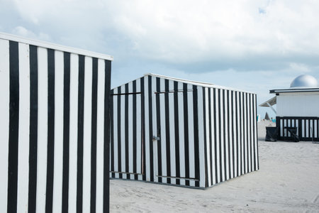 Striking black and white verticlly striped beack shed on beach Miami, Florida