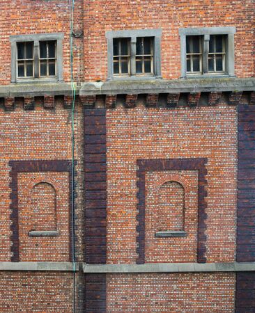 Brick wall with windows and architectural features, full frame background.の写真素材