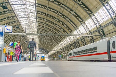 AMSTERDAM, HOLLAND - AUGUST 21, 2017; Centraal station roof architecture and people on platform waiting for their trainのeditorial素材