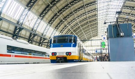 AMSTERDAM, HOLLAND - AUGUST 21, 2017; Centraal station roof architecture and people on platform waiting for their trainのeditorial素材