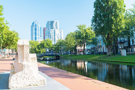 ROTTERDAM, HOLLAND- AUGUST 23, 2017; Public art sculpture along grassy embankments and paved walkway along  Westersingel Canal with some of city's amazing architeure in backgroundのeditorial素材