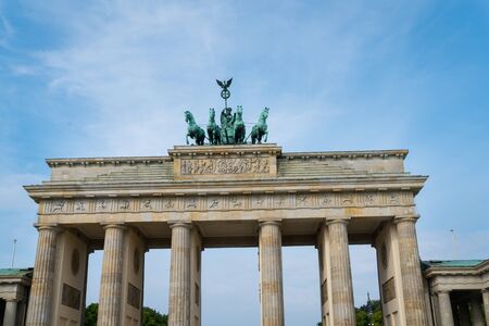Neo-classical architecture and bronze statue four hourses pulling chariot on top of the Brandenburg Gateの写真素材