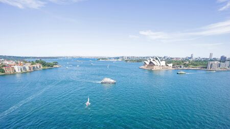 Wide angle view Sydney harbour and surrounds, from Harbor Bridge beautiful blue water, boats and ferries crossing from one side to other, surrounding land, buildings and landmarks.の写真素材