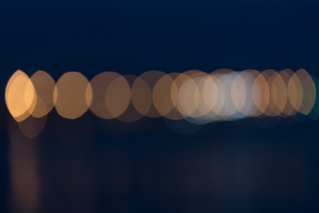 Abstract city lights across calm harbor abstract backgroundの写真素材