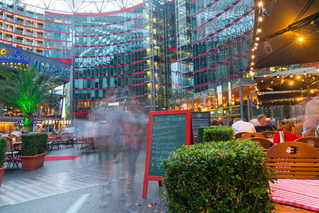 BERLIN, GERMANY - AUGUST 28 2017; People seated at restaurants and blurred in motion by long exposure in Sony Center courtyard and mall at Potsdamer Platz, Berlin.のeditorial素材