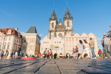 PRAGUE, CZECH REPUBLIC,- 29 AUGUST 29, 2017;  Sun highlights Gallery of Art  and tourists in old Twon Square in front of gothic towers of Church of Our Lady before Tyn low point of view.のeditorial素材