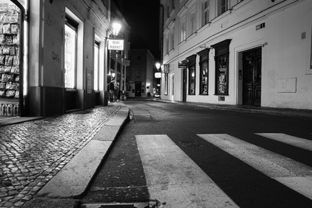 PRAGUE, CZECH REPUBLIC - AUGUST 30, 2017; shopping street passing people blurred in motion at night long exposure under glow of street lights.のeditorial素材