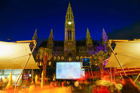 VIENNA,AUSTRIA - SEPTEMBER 4 2017; Film Festival night event with screening, food outlets and crowd of people in attendance and silhouette of city hall behind.のeditorial素材