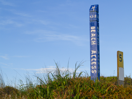 Blue beach access sign on Papamoa dunes.の写真素材