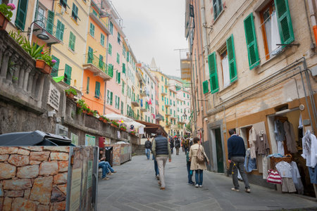RIOMAGGIORE ITALY - APRIL 24 2011;  People passing along narrow lane between characteristic...