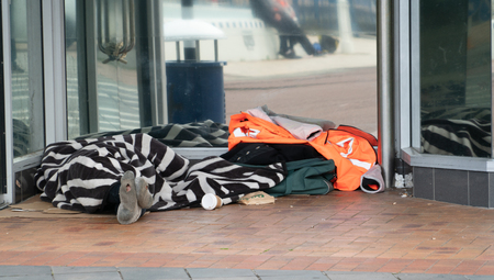 TAURANGA NEW ZEALAND - SEPTEMBER 22 2018;  Homeless people asleep under rugs in downtown doorwayのeditorial素材