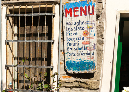 VERNAZZA, ITALY - APRIL 26 2011; Italian village typical pizzeria food shop signage  advertising different offerings with little picturesのeditorial素材