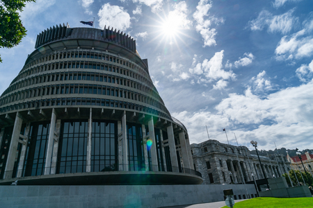 WELLINGTON, NEW ZEALAND - OCTOBER 1 2018; Sun bursts over capital city  parliament buildings icluding circular conical shaped building known as Beehive.のeditorial素材
