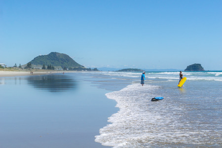 TAURANGA NEW ZEALAND - DECEMBER 18,2018; Long view beautiful ocean beach with people enjoying the weather and beach activities.のeditorial素材
