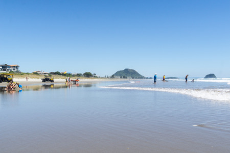 TAURANGA NEW ZEALAND - DECEMBER 18,2018; Long view beautiful ocean beach with people enjoying the weather and beach activities.のeditorial素材