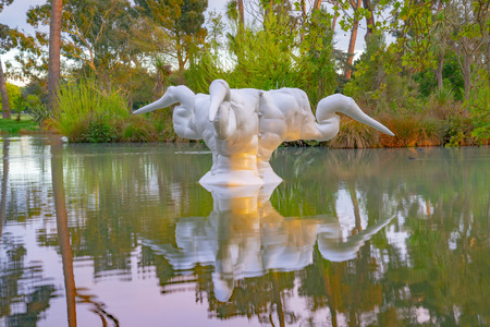 CHRISTCHURCH NEW ZEALAND - OCTOBER 10 2018 Kotuku, white fibreglass sculpture of three heads of white heron in Christchurch Botanic Gardens by Caroline Rothwell in 2002のeditorial素材