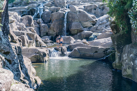 TAURANGA NEW ZEALAND - JANUARY 23 2019; Scenic waterfalls at with people enjoying the cool water experiences on hot summer day at McLaren Falls Parkのeditorial素材