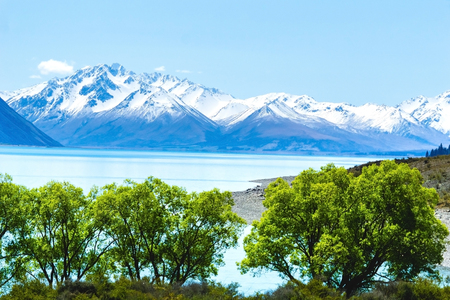 Lake Tekapo  mid image layer stunning scenery foreground layer and distant snow capped Southern Alps in rear focus layerの写真素材