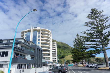 MOUNT MAUNGANUI NEW ZEALAND - FEBRUARY 8 2019:Apartment buildings on Mount Maunganui Marine Parade with landmark mount in backgroundのeditorial素材