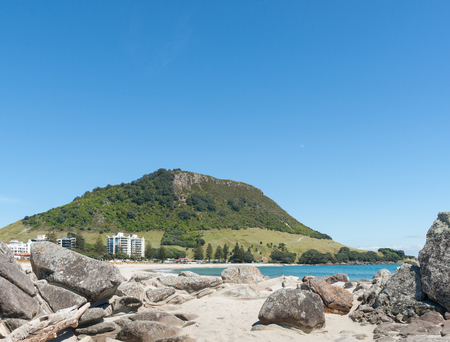 Mount Maunganui beach and landmark from rocky foreshore of Leisure Island.の写真素材