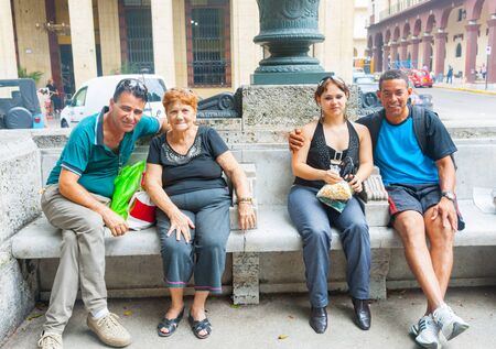 HAVANA CUBA - JUNE 30 2012; Authentic Cuban people relaxing on city bench seat smilingのeditorial素材