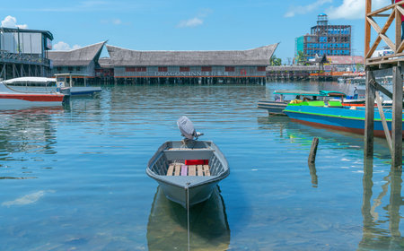 SEMPORNA SABAH - MAY 10 2019;  tourist small boat harbour dinghy tied up near pier with famous...
