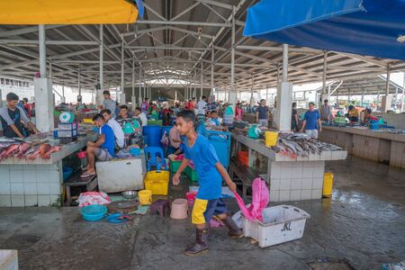 KOTA KINABALU BORNEO - MAY 31 2019; Workers, vendors and fresh seafood in city's wet or fish market near wharf.のeditorial素材