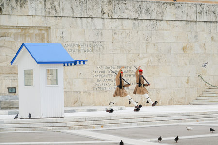 ATHENS GREECE - JULY 15 2019; Presidential Guard outside Presidential Mansion and wall with greek character signs guards Tomb of Unknown Soldier.のeditorial素材