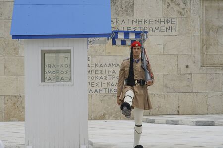 ATHENS GREECE - JULY 15 2019; Presidential Guard outside Presidential Mansion and wall with greek character signs guards Tomb of Unknown Soldier.のeditorial素材