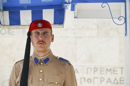 ATHENS GREECE - JULY 15 2019; Looking serious Presidential Guard outside Presidential Mansion and wall with greek character signs guards Tomb of Unknown Soldier.のeditorial素材