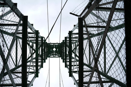 Steel structural pylon from underneath with cables and cross bracing