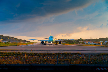 Passenger aircraft taxiing on runway at airport at Skiathos, Greece.の写真素材