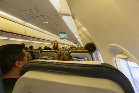 Athens Grece - August 6 2019; Travelers and seating inside  passenger plane en-route.のeditorial素材