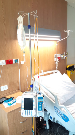 Queensland Australia - November 19 2019; Inside hospital ward with bed and drip pump machines and monitor beside empty bed.のeditorial素材