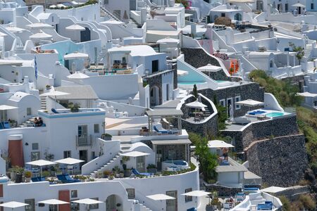 Santorini Greece - August 10 2019;  Walls, stairs,and architecture of typical white homes and hotels of Fira packed in togetherのeditorial素材