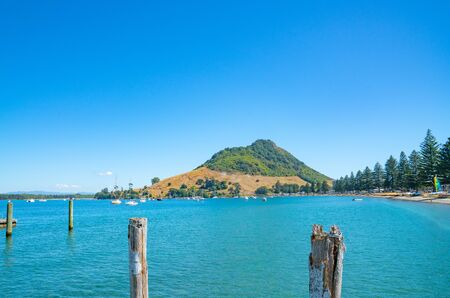 Tauranga New Zealand - Mount Maunganui at northern end Pilot Bay beyond turquoise waterの写真素材