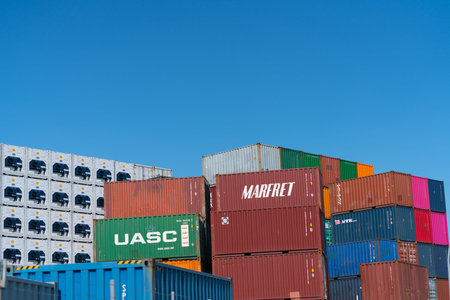 Tauranga New Zealand - January 23 2020; Cargo containers of different colors stacked high on angles