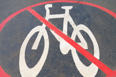 No cycling zone symbol on pavement red crossed circle with white cycle graphic.のeditorial素材