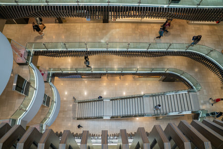 Melbourne Australia - March 9 2020; People on escalator surrounded by monochromatic patterns in...