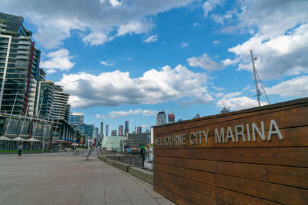 Melbourne Australia - March 11 2020; city commercial skyline from Docklands district and Melblourne Marina where promenade is nearly empty of people due to coronavirus pandemic.のeditorial素材