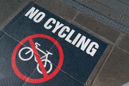 No Cycling footpath sign white on black with red symbol.の写真素材