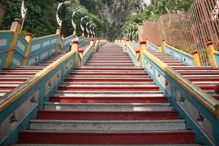 Steep yellow, blue and red step leading upward to sacred Batu Caves in Kual Lumpur.の写真素材