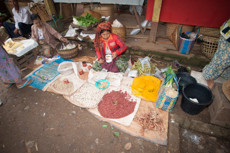 Inle lake Myanmar - November 3 2013; women at Inle Lake floating markets selling their produce and wares.のeditorial素材