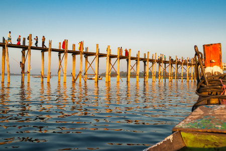 U Bein Bridge, November 6 2013; People walking and fishing in distance on bridge spanning Taungthaman Lake near Amarapura in Myanmar.のeditorial素材