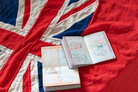 New Zealand passports open on background flag of country.の写真素材
