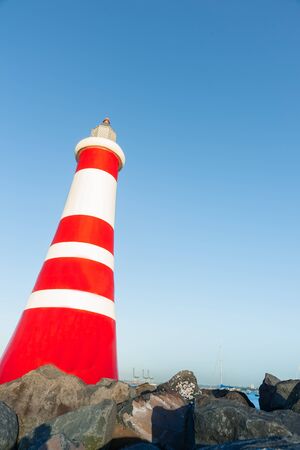 Marina beacon red and white stripes marks entrance to marina.の写真素材
