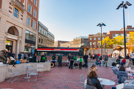 Boston, USA - October 13 2014; People outdoors at entrance to Harvard  Train Station arriving,...