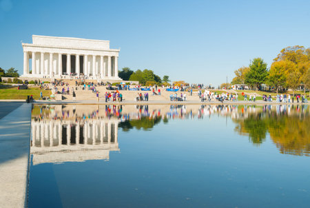 Washington DC USA - October 26 2014; People on steps of Lincoln Memorial reflected in calm of...