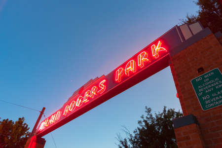 Clinton USA - September 10 2015; Art deco McLain Rogers Park sign illuminated bright red at night at entranceのeditorial素材
